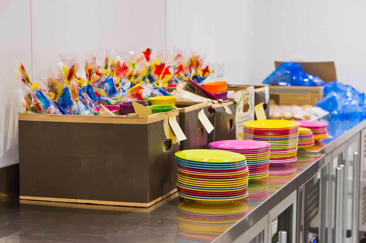 A line of colorful goodie bags on a counter.