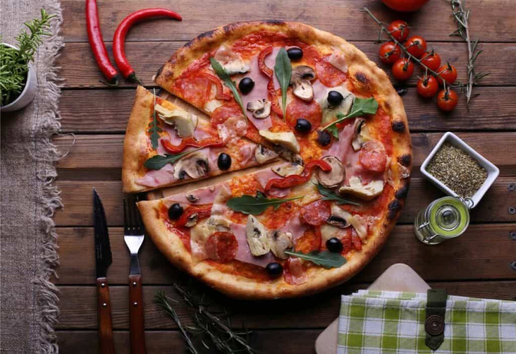 Learn how to make a pizza sitting on a wooden table better.