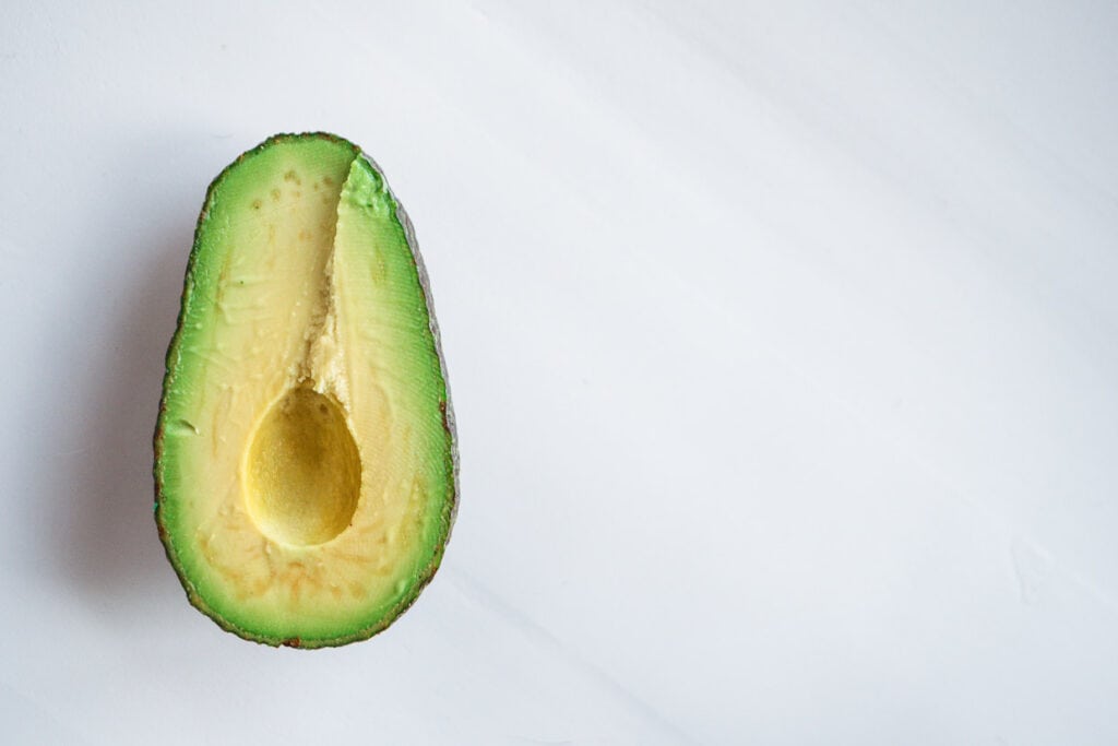 A half avocado on a white background.