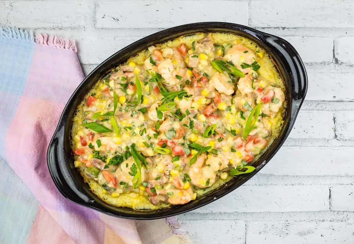 A casserole dish with chicken and vegetables in it.