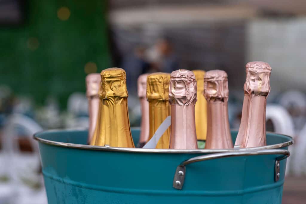 Champagne bottles in a bucket at a wedding.