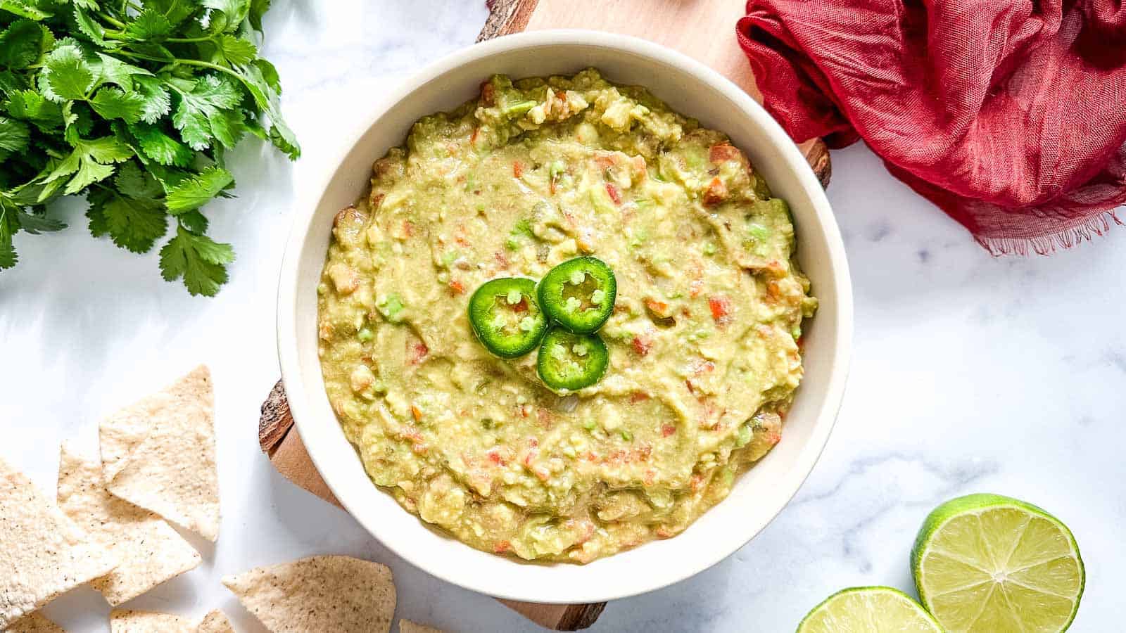 Guacamole in a bowl with tortilla chips.