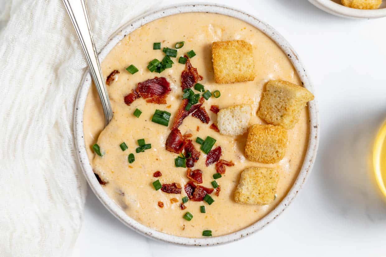 A bowl of creamy and cheesy beer cheese soup.