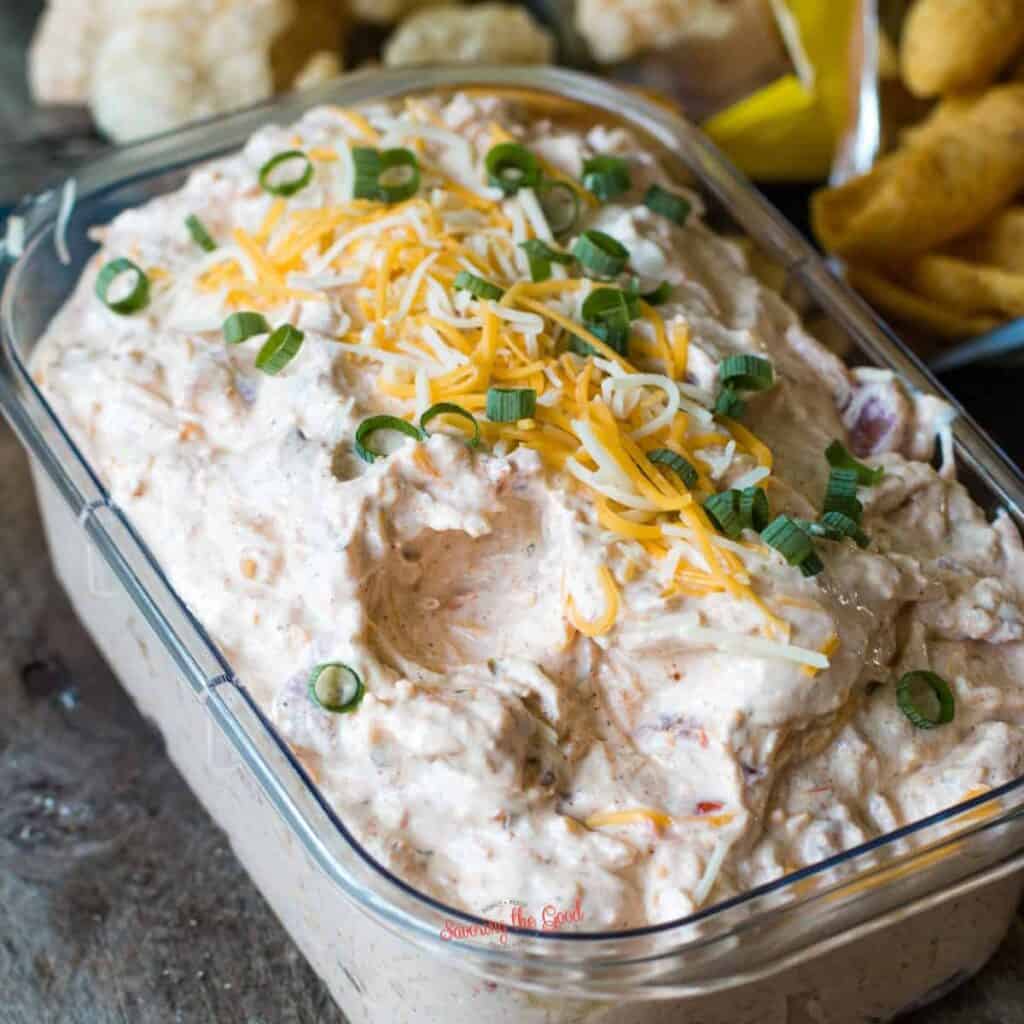 Cheesy chicken dip in a glass container.