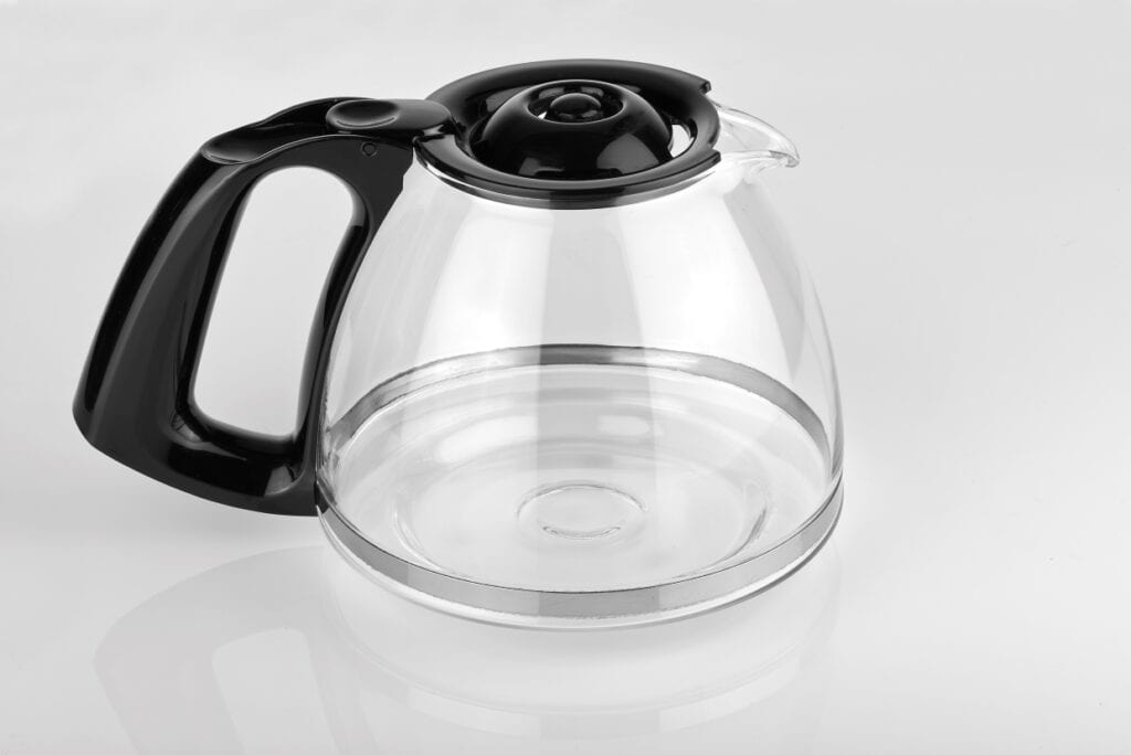 A glass coffee carafe on a white background.