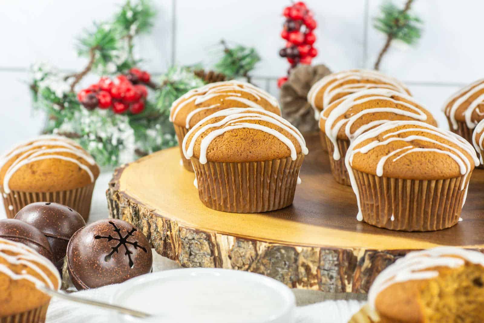 Gingerbread muffins with icing on a wooden board.