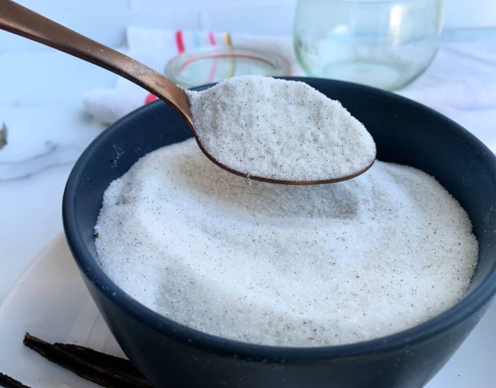 Vanilla sugar in a bowl with a spoon.