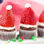 Santa hat mini Christmas muffins on a white plate.