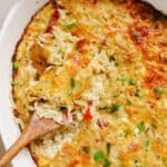 Hash brown breakfast casserole with a wooden spoon in it.