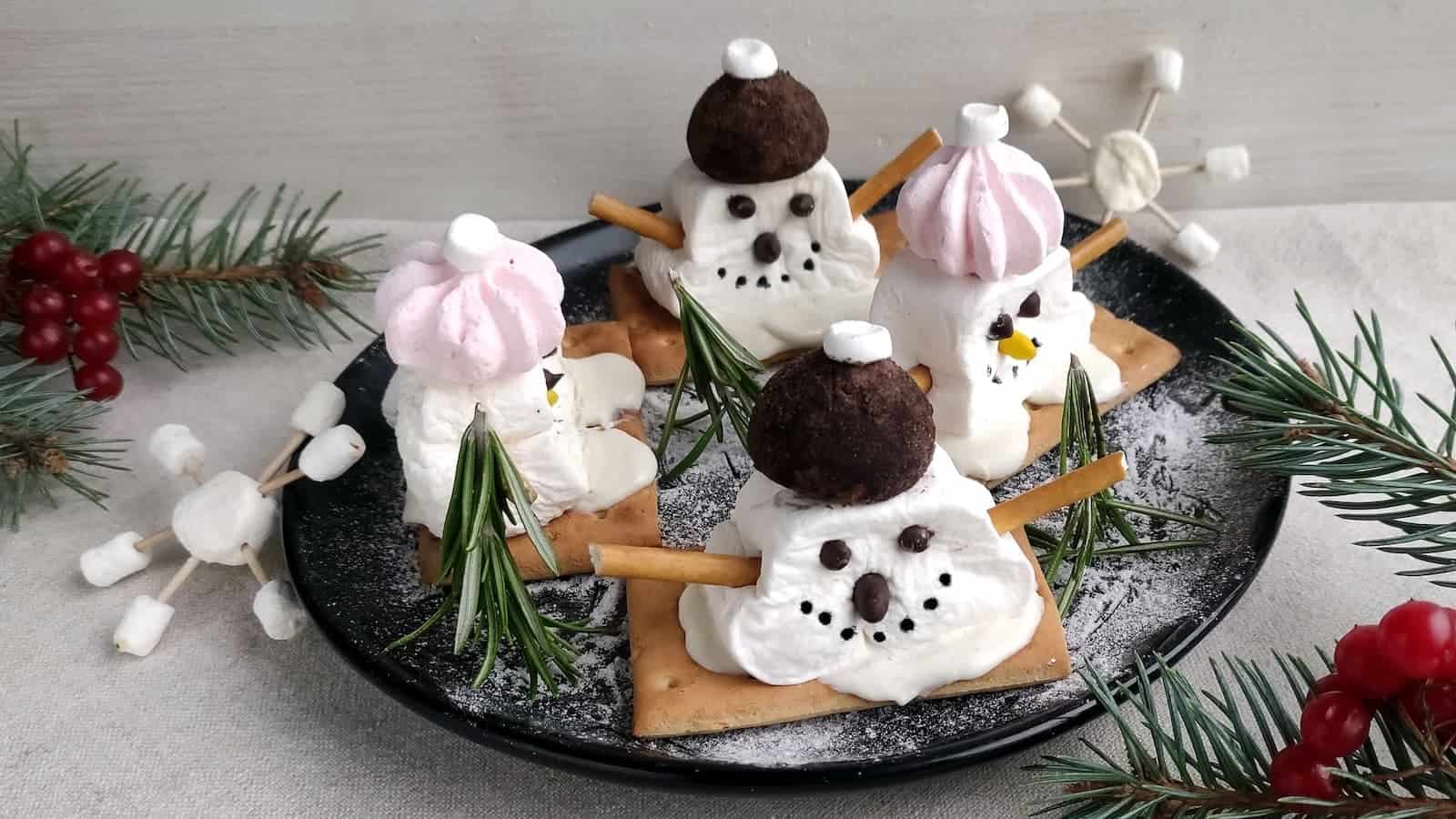 A plate of melting snowman marshmallows and rosemary trees.