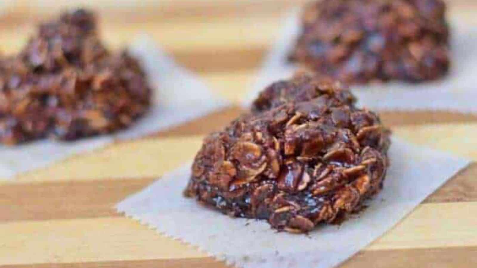 Image shows no bake nutella cookies on wax paper sitting on a wooden board.