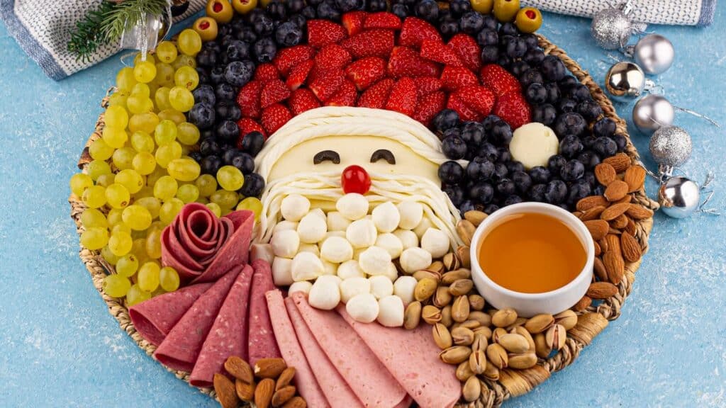 Santa Claus cheese platter with fruit and nuts.