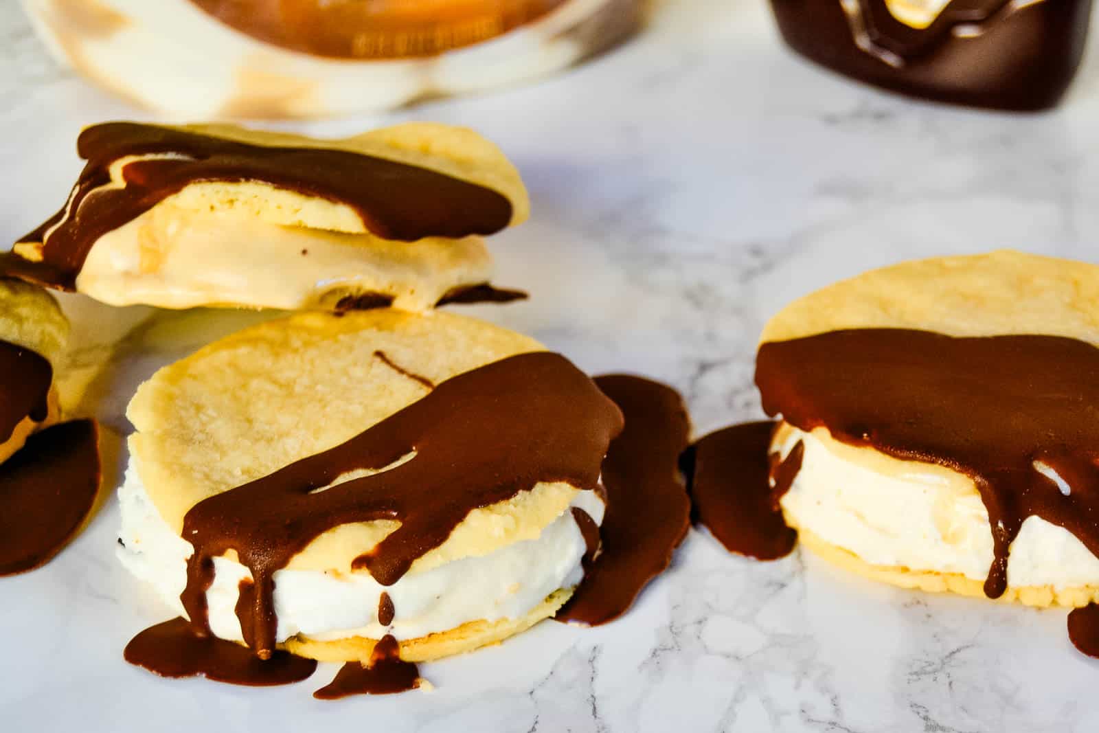 Ice cream sandwiches with chocolate drizzle.