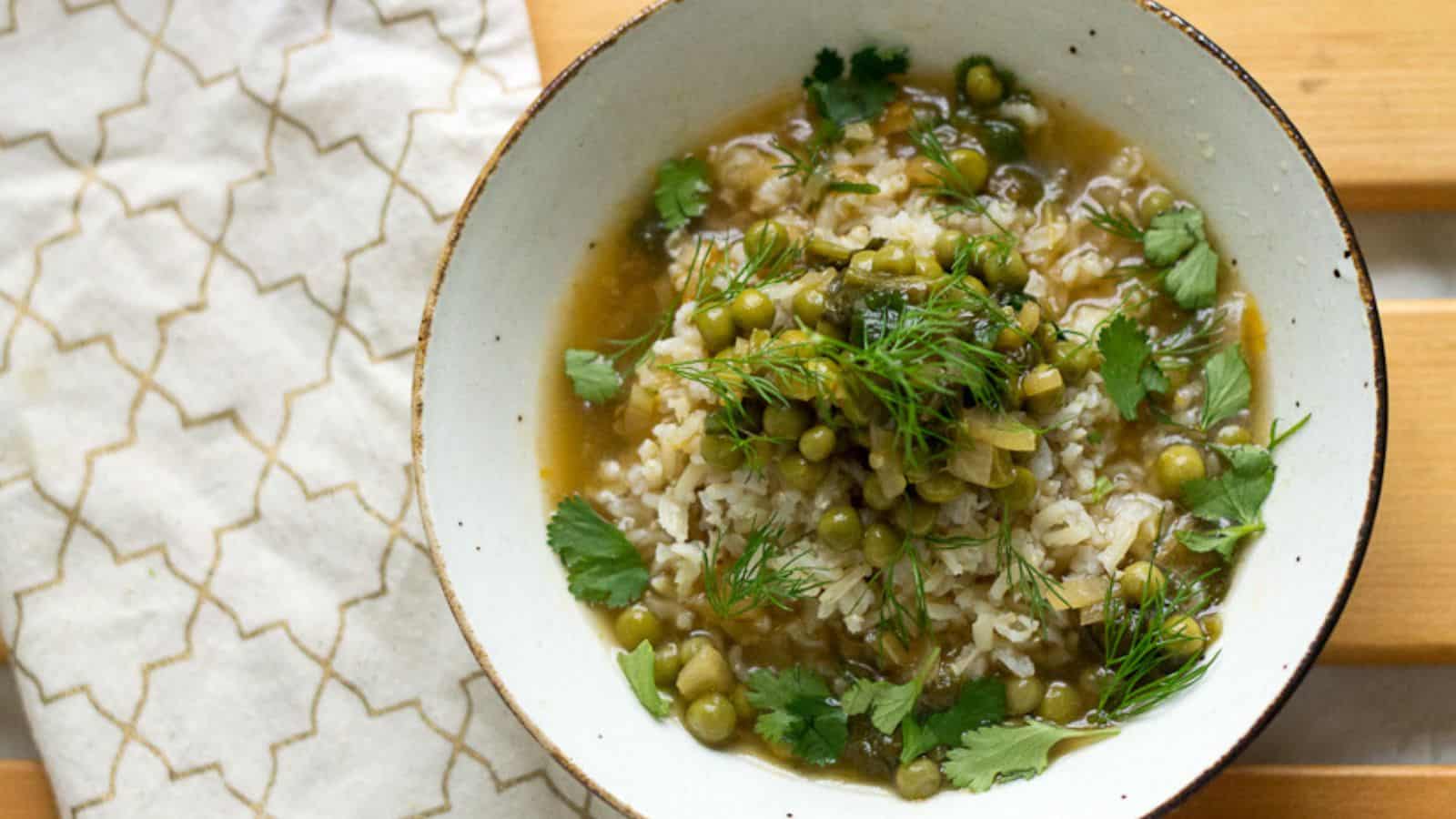 A bowl of rice and peas, a delectable veggie main, on a rustic wooden table.