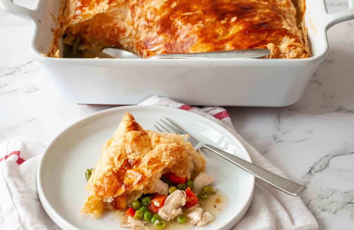 A plate with pot pie on it and a fork.