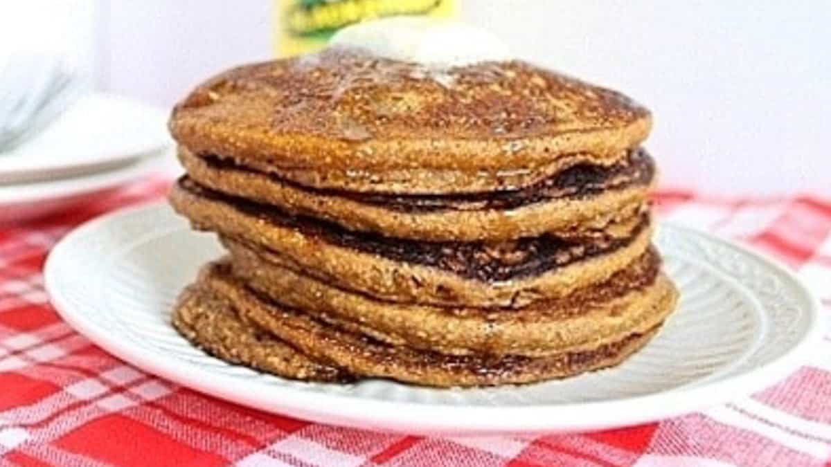 A stack of gingerbread pancakes on a plate.