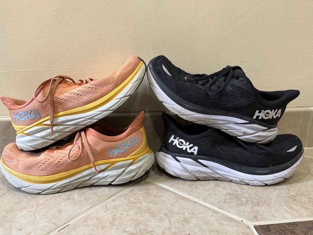 Three hoka one one running shoes on a tile floor, requiring cleaning techniques for sneakers.