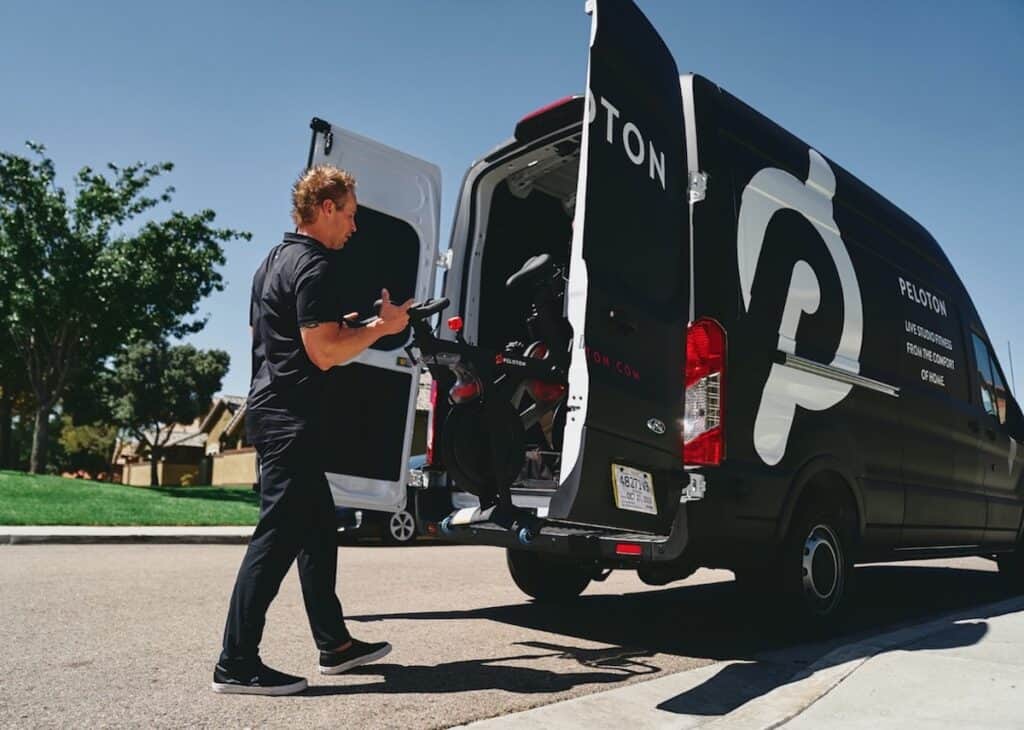 A man doing easy at-home workouts in front of a black van.