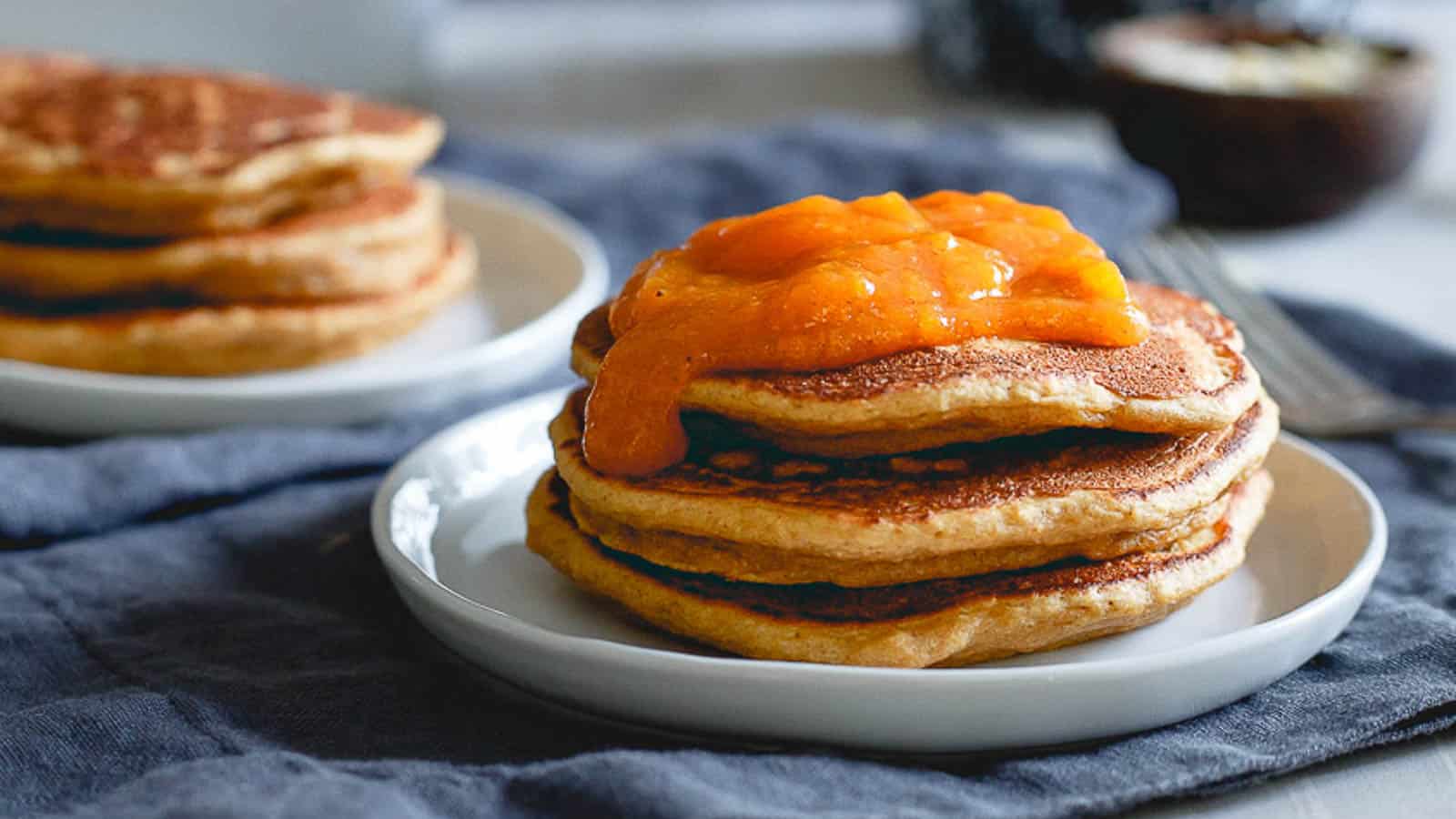 A stack of pancakes topped with persimmon sauce.