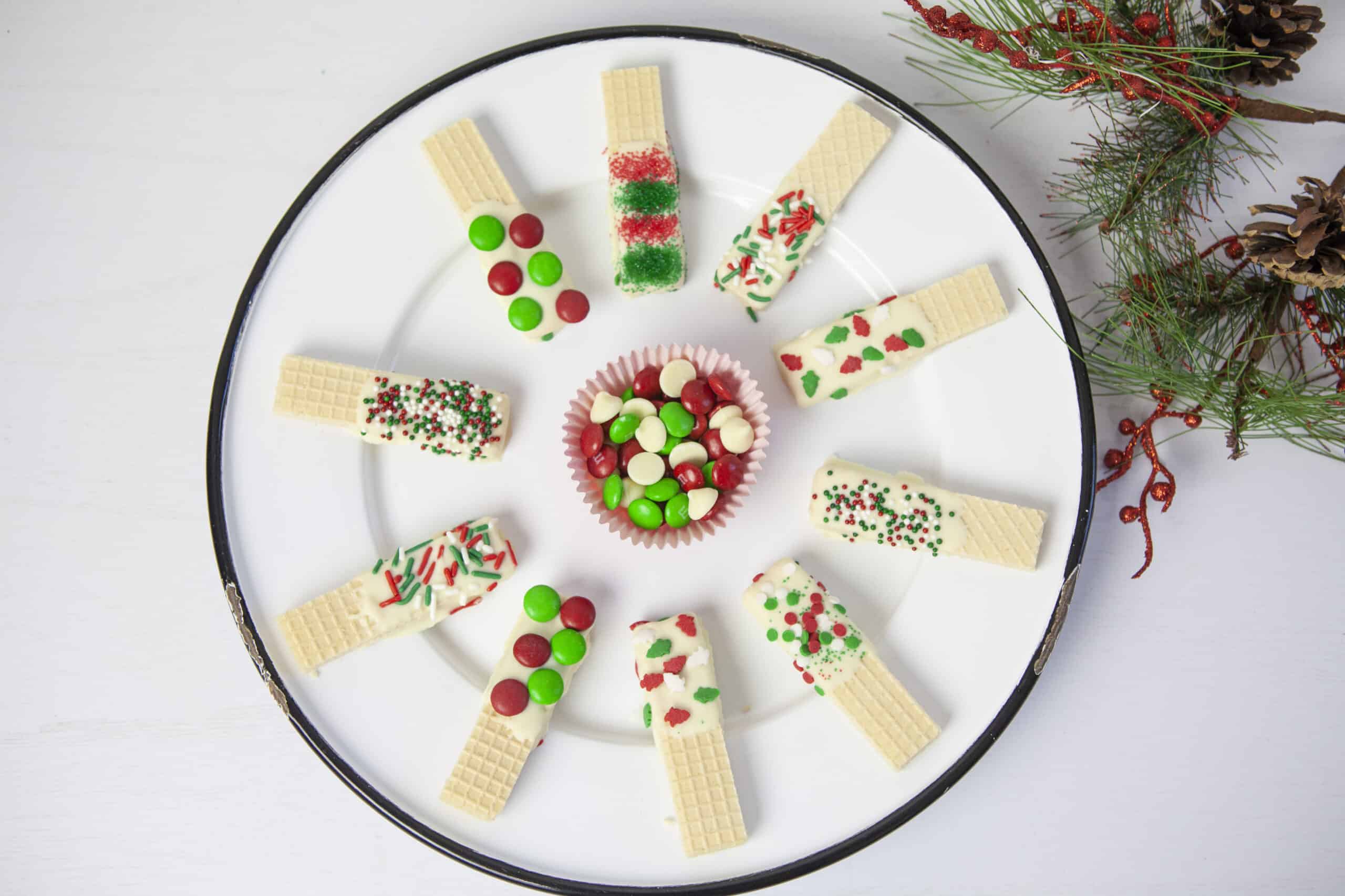 A plate with Christmas wafer cookies on it.