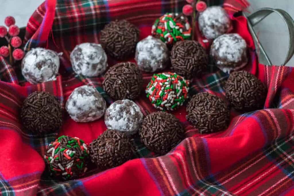 Chocolate rum balls on a red tartan cloth.