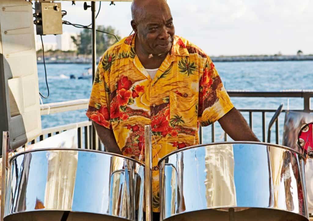 A man playing steel drums on a boat.
