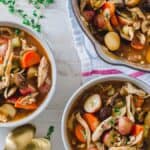 A bowl of turkey stew with carrots and potatoes.