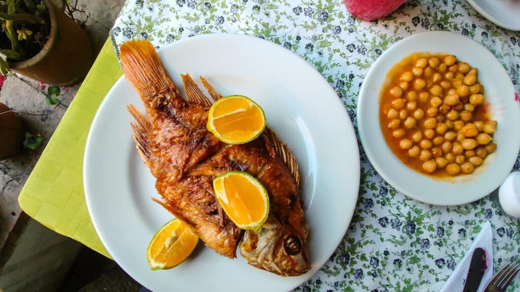 A plate of fish and beans on a table at one of the best restaurants in Bogota.