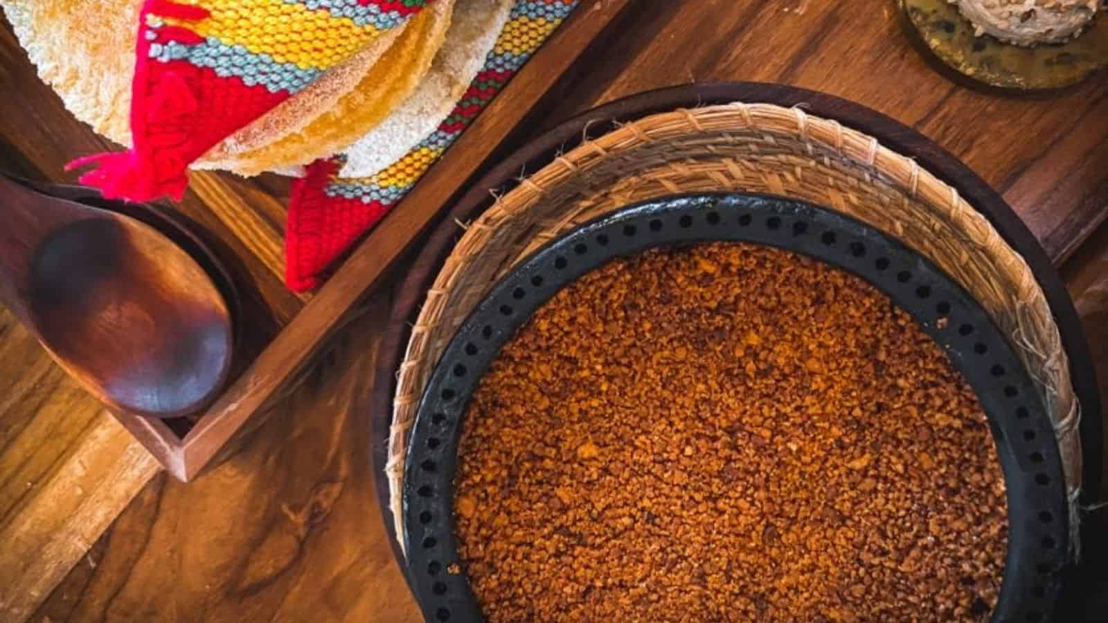 A Mexican dessert in a bowl on a wooden table.