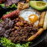 A plate packed with mouthwatering meat, eggs, and vegetables served at one of the best restaurants in Bogota.