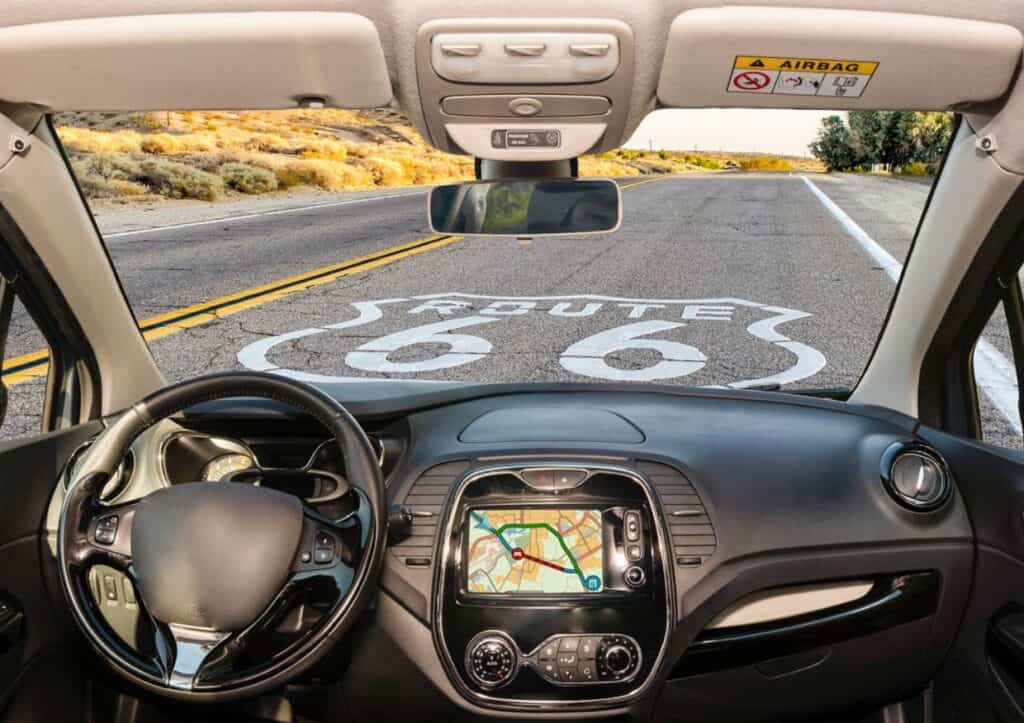 The interior of a car with a map on the dashboard, ready for an adventurous Route 66 road trip.
