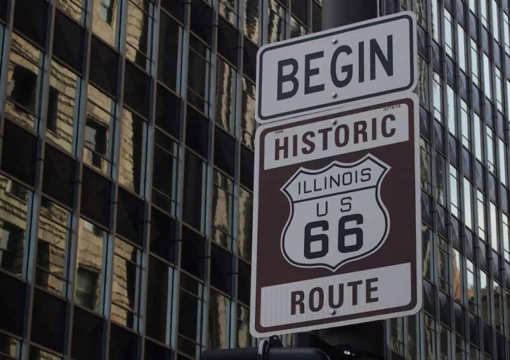 A sign that says begin historic route 66 in Illinois, inviting road trip enthusiasts to embark on the legendary route.