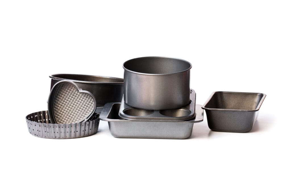 A set of metal baking pans on a white background.