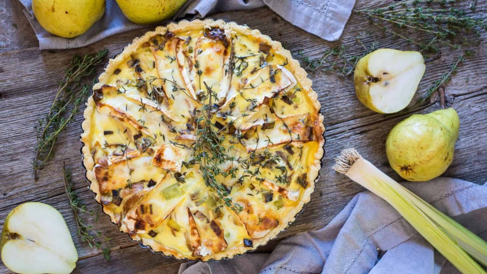 A quiche with pears and sprigs of thyme.