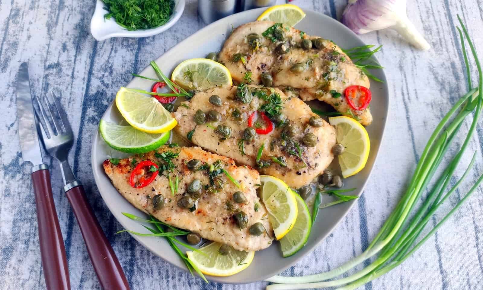 Chicken piccata with lemon and capers on a plate.