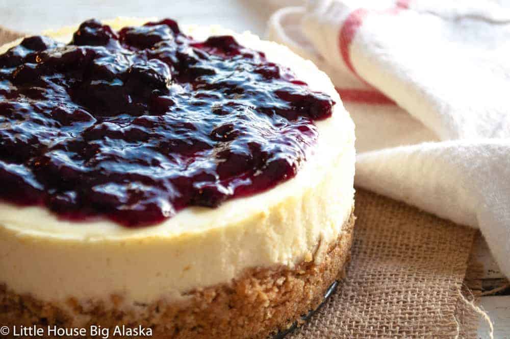 A small cheesecake with berries on top.