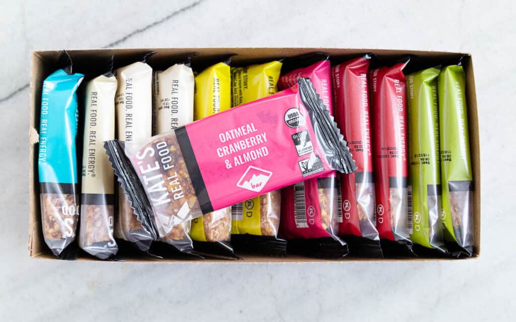 A box containing a variety of Kate's Real Food snack bars.