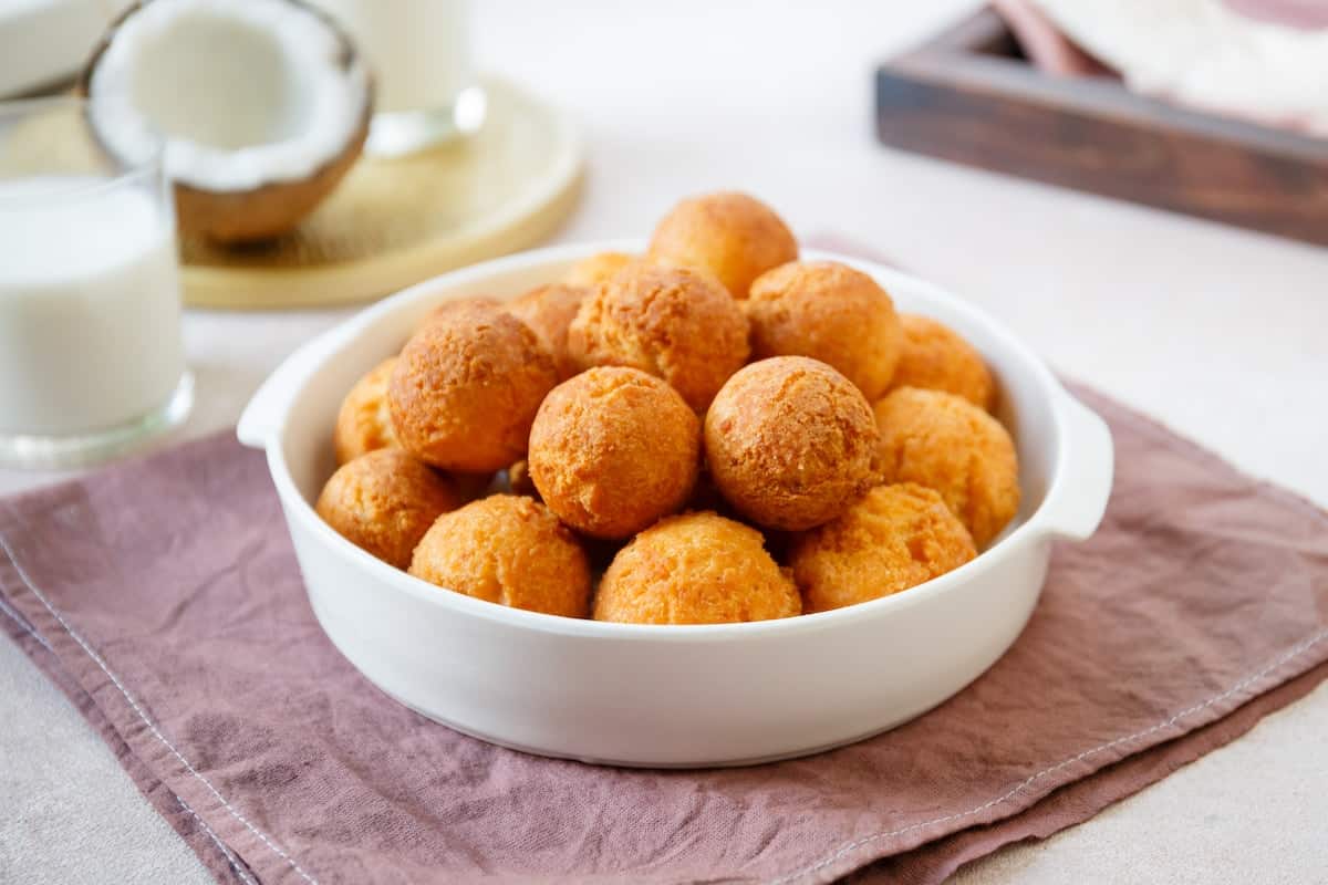 A bowl of fried Nigerian buns on a table.