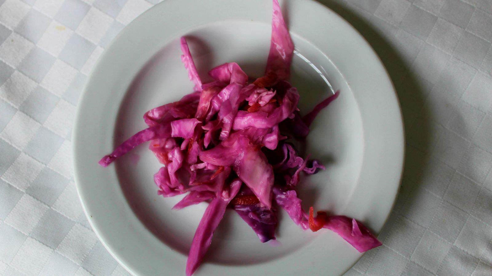 Red cabbage on a white plate.
