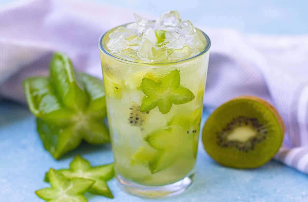 Homemade Starbucks kiwi starfruit refresher recipe served over ice with tropical fruit flavors.