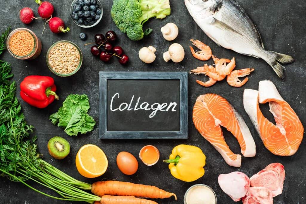 A chalkboard with the word collagen surrounded by fish, vegetables, and other foods highlighting the benefits of collagen powder.