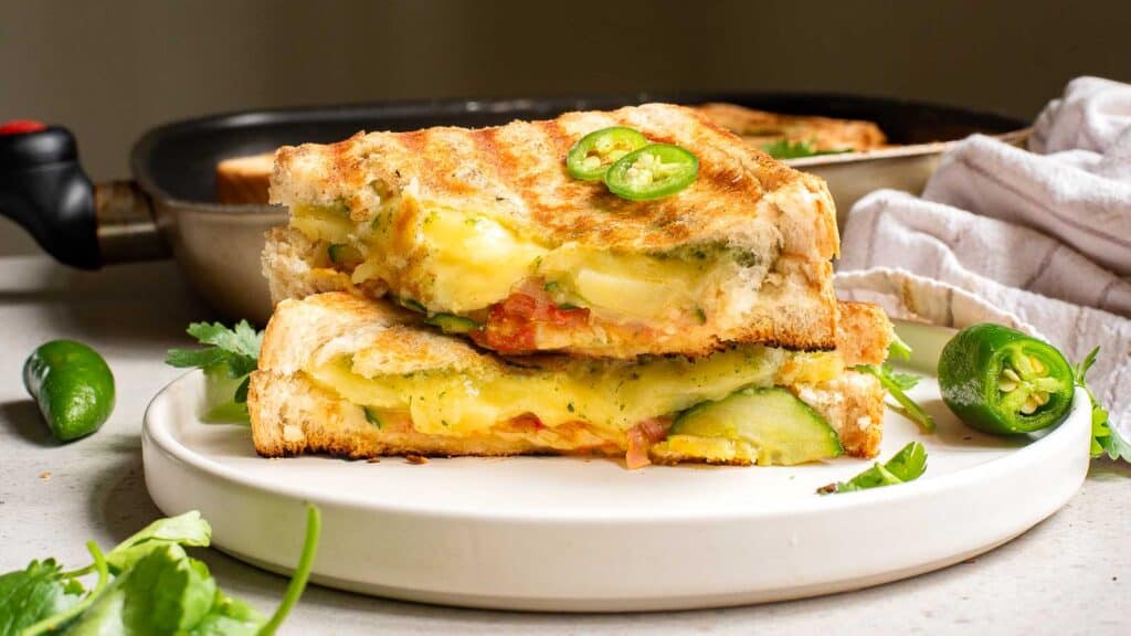 A grilled cheese sandwich with jalapeno and cheese on a plate.