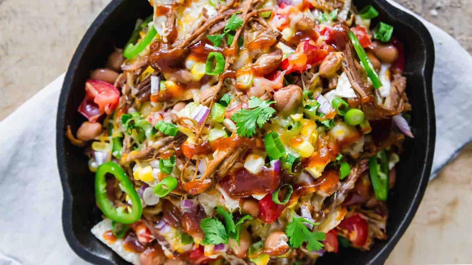 Mexican nachos in a cast iron skillet.