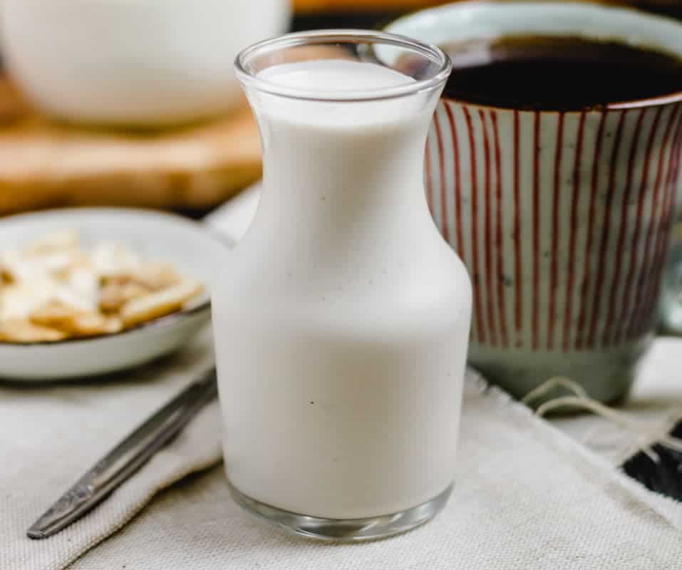 A glass jar of cashew coffee creamer.