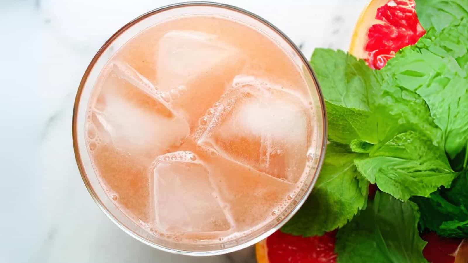 Overhead image of a glass of grapefruit juice.