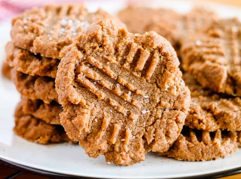 A stack of keto peanut butter cookies sprinkled with salt.