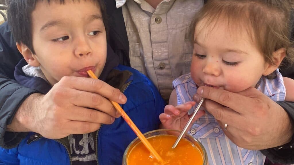 A man and a child enjoying freshly squeezed orange juice in Mexico City.