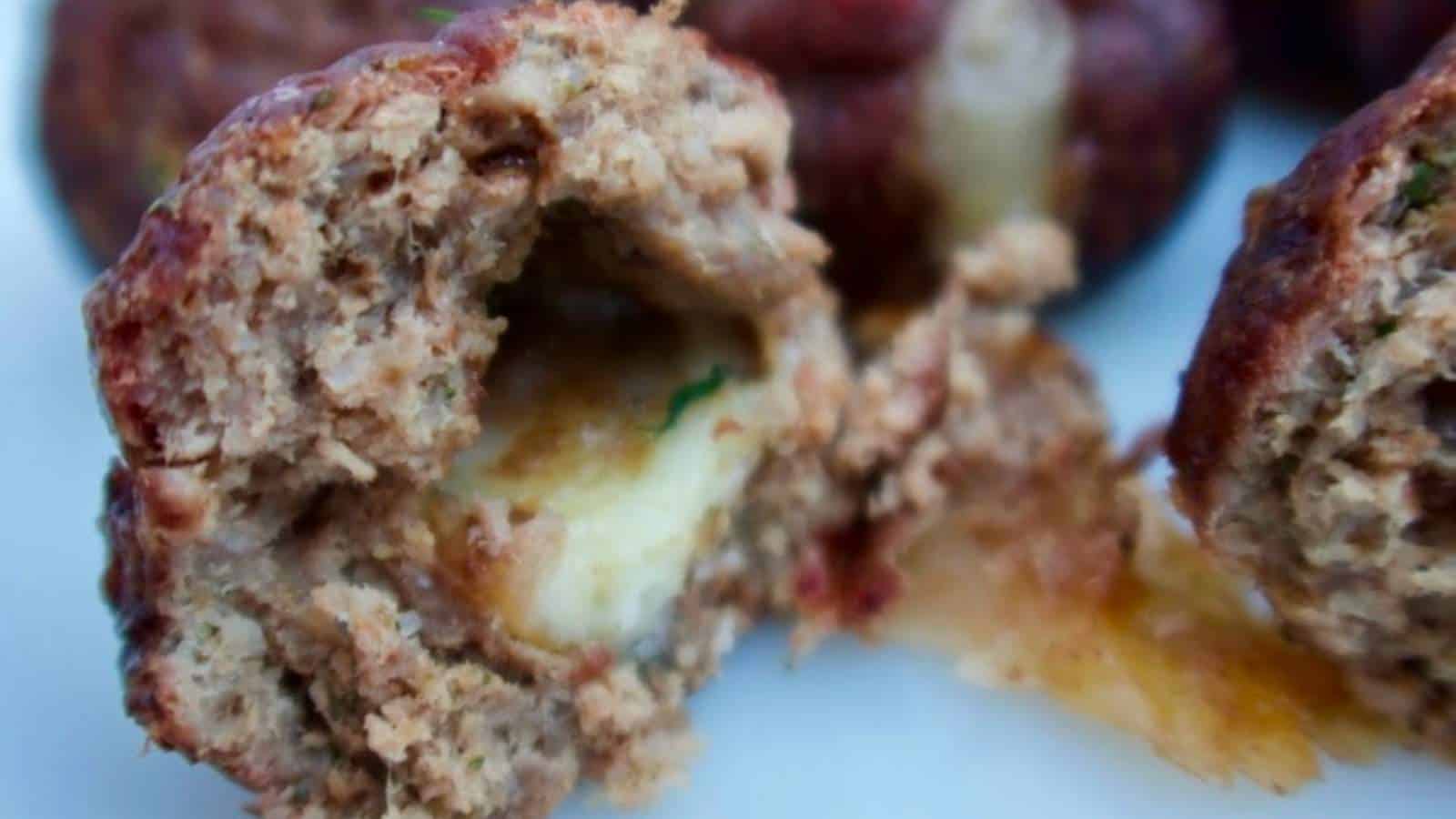 Meatballs with cheese on a plate.