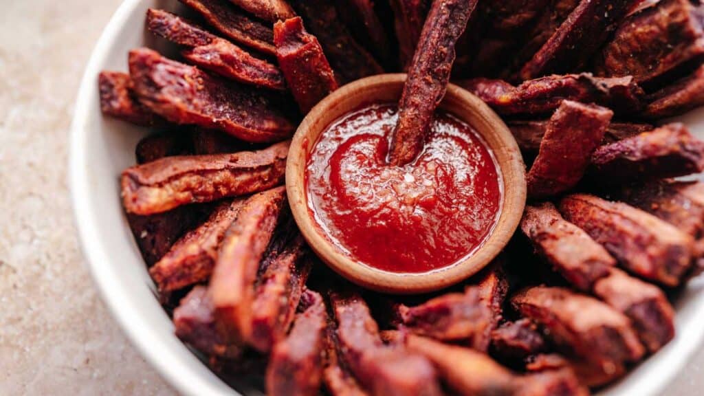 Sweet potato fries with ketchup in a bowl.
