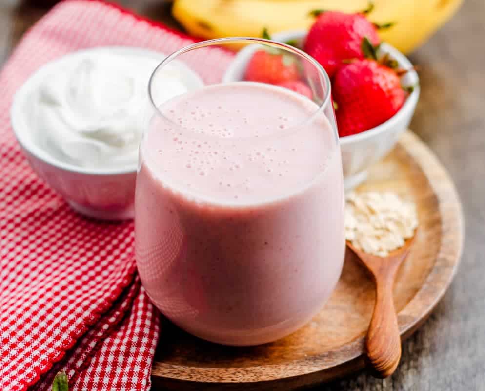 A glass of strawberry banana oatmeal smoothie.